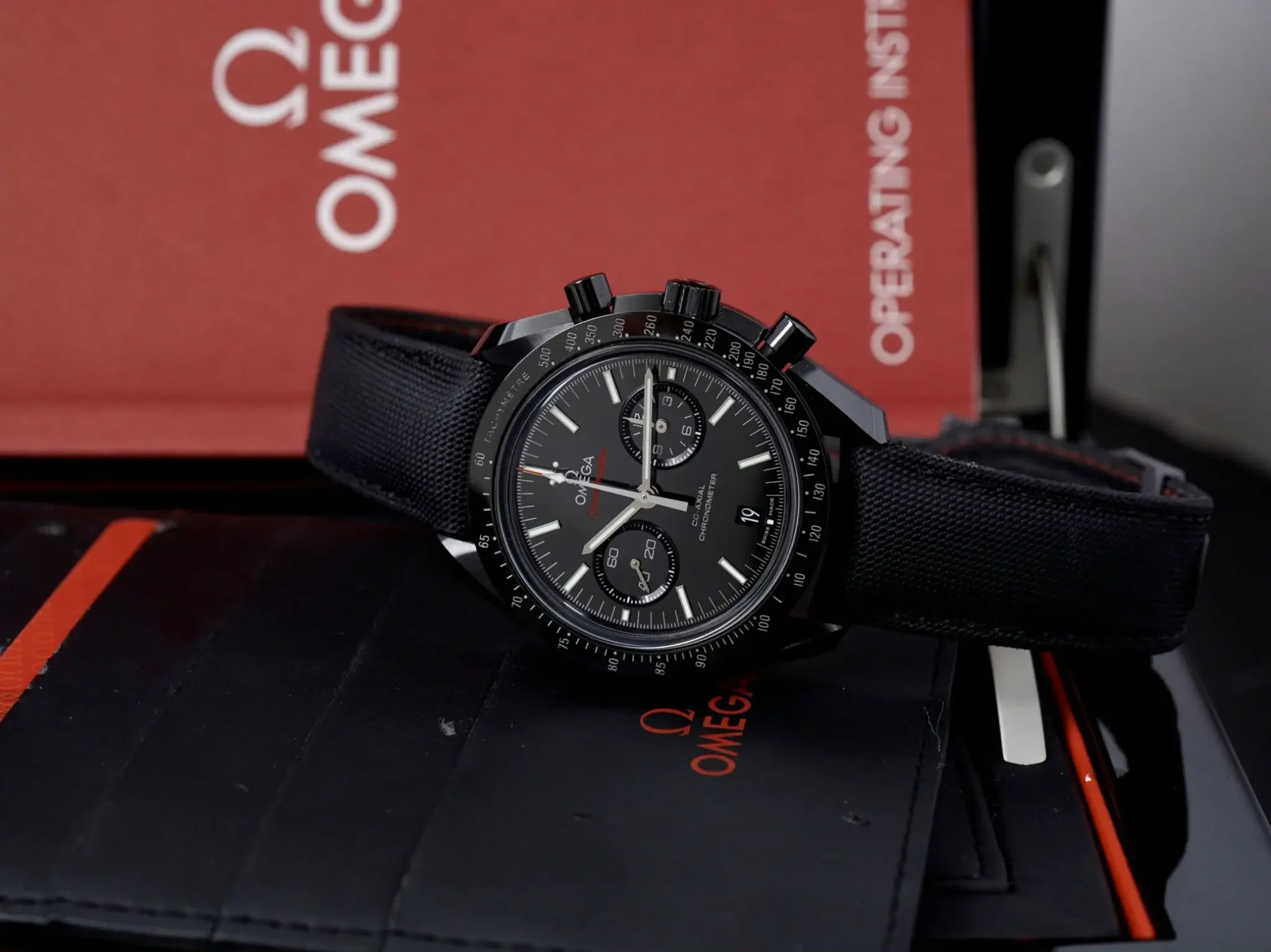 Đồng hồ Omega Speed Master Dark Side Of The Moon 311.92.44.51.01.007 mặt số màu đen. Thiết kế lộ cơ. Dây đeo bằng vải. Thân vỏ bằng ceramic.